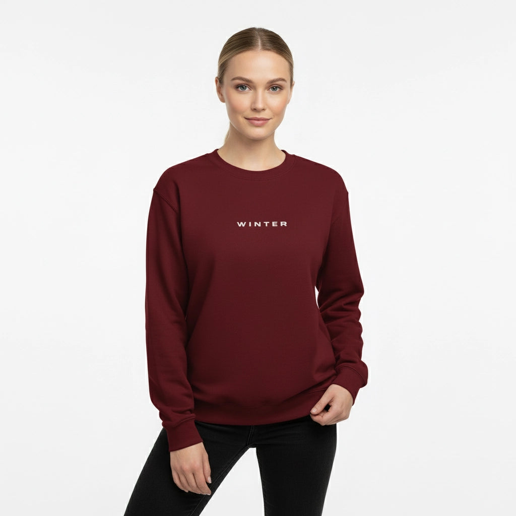 Woman wearing a maroon sweatshirt with 'WINTER' text on a white background