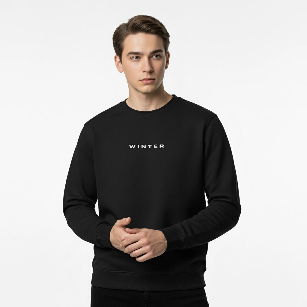 Person wearing a black sweatshirt with 'WINTER' text on a white background