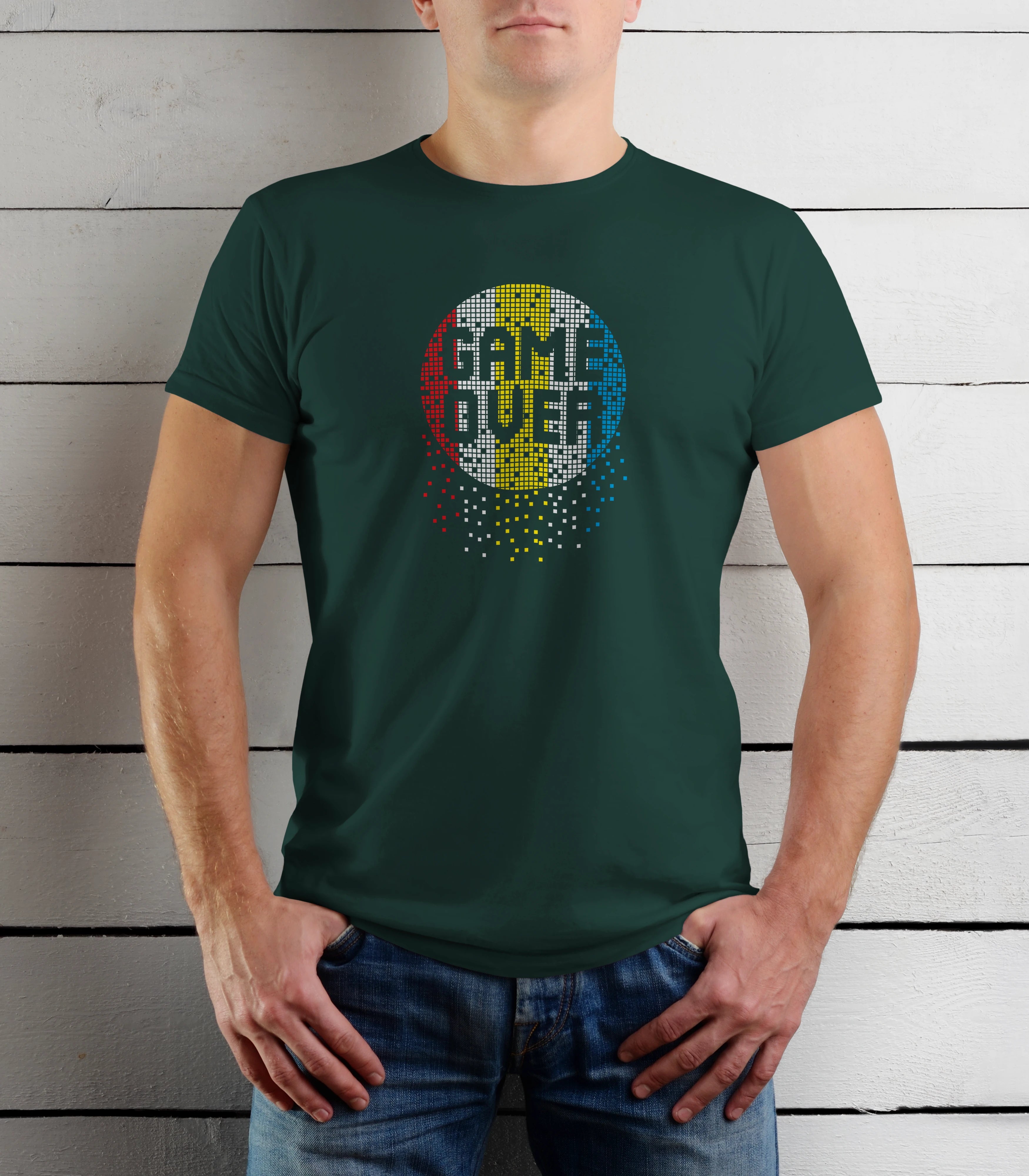 Person wearing a green t-shirt with a colorful graphic design on a wooden background