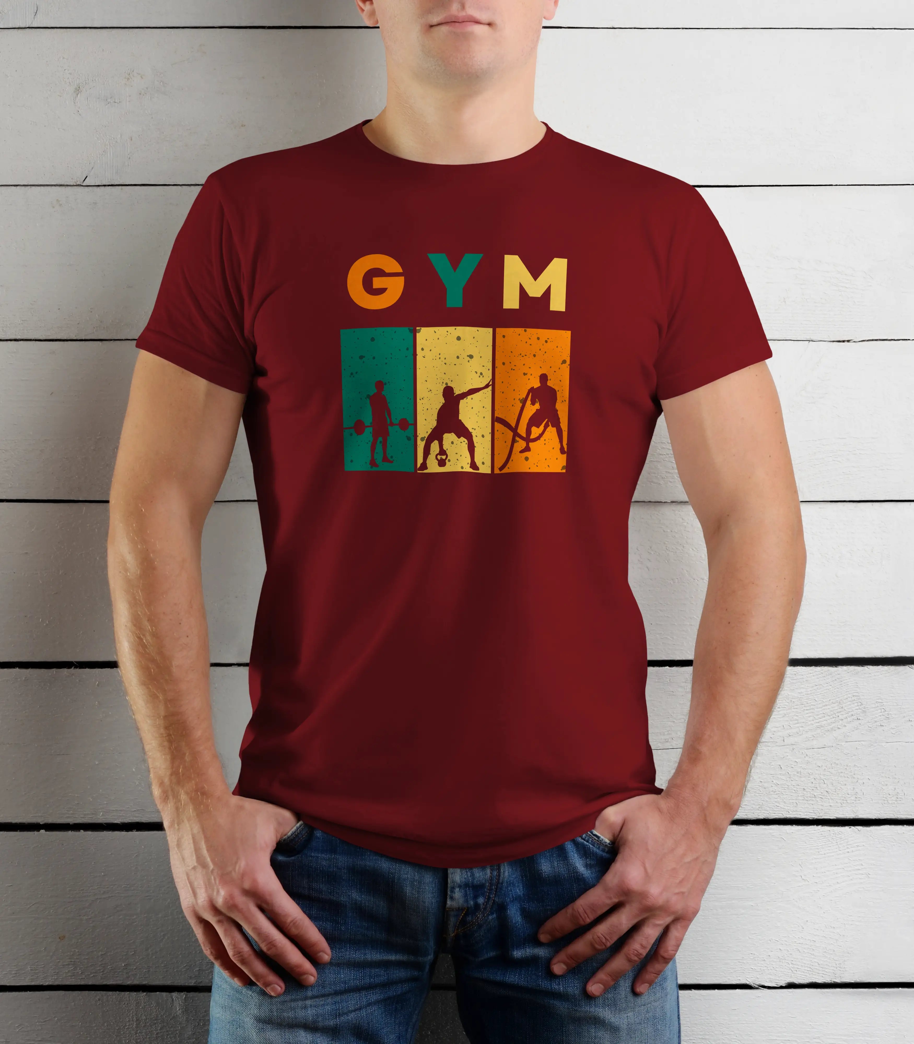 Person wearing a maroon t-shirt with 'GYM' and gym-themed graphics against a wooden background