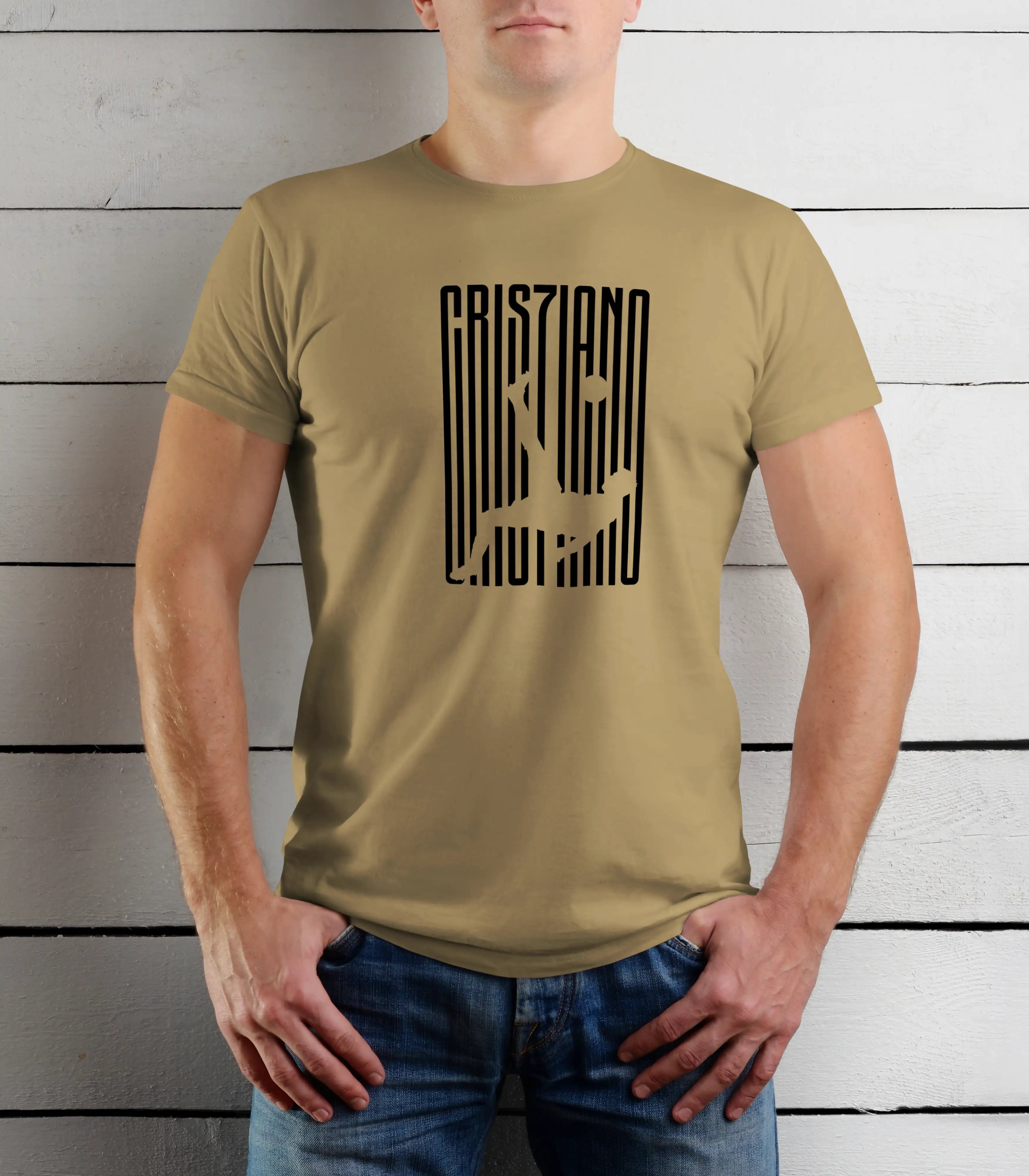 Person wearing a beige t-shirt with a black graphic design against a wooden background