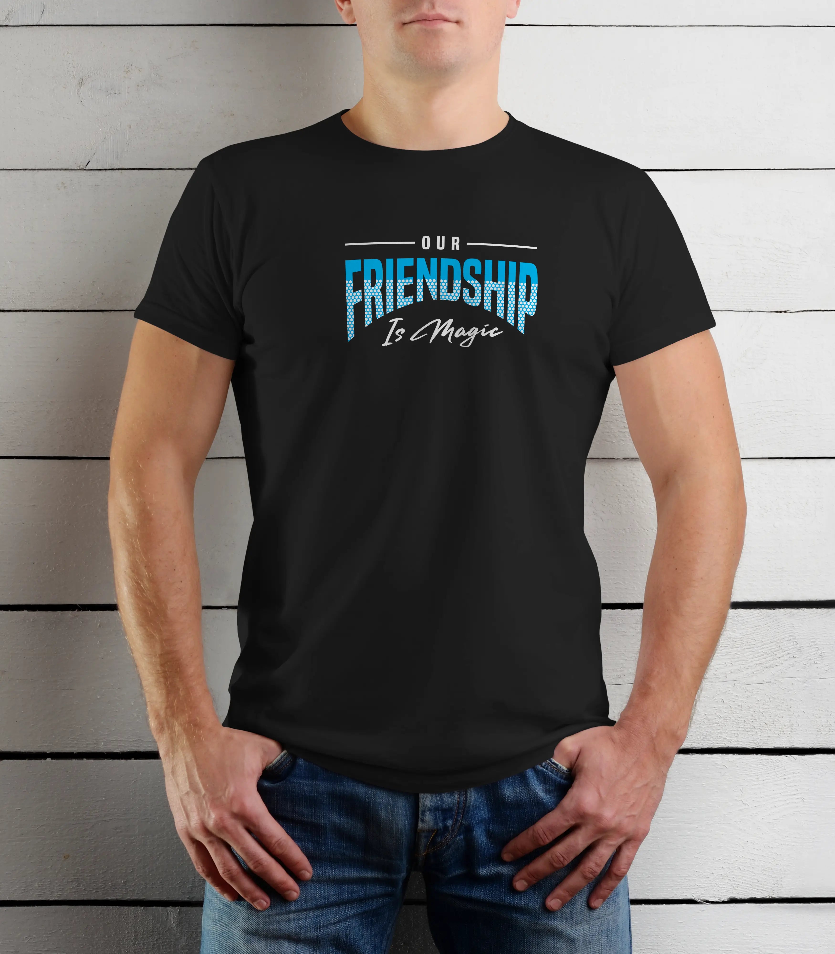 Person wearing a black t-shirt with 'Our Friendship Is Magic' text against a wooden background