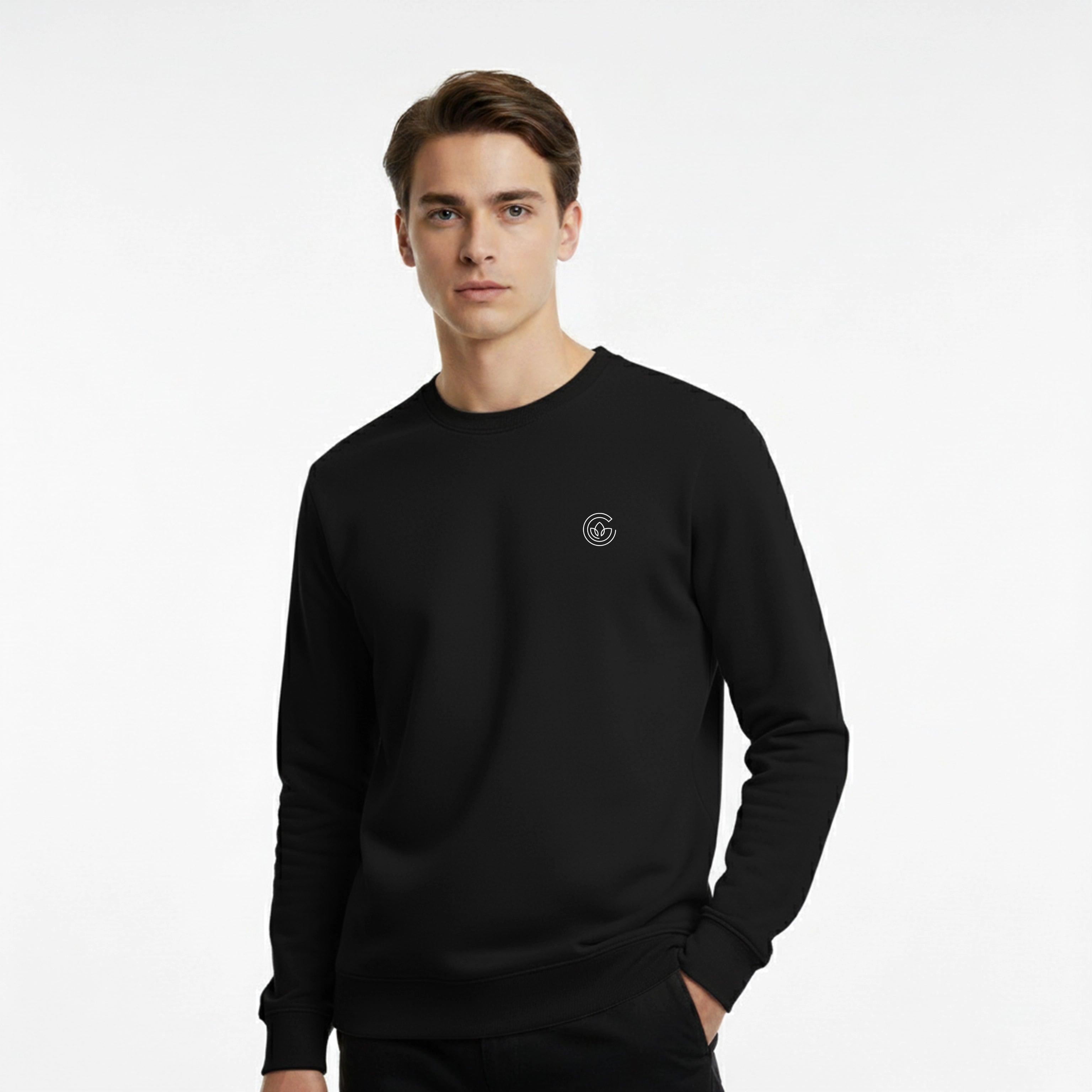 Man wearing a black sweatshirt with a small logo on a white background