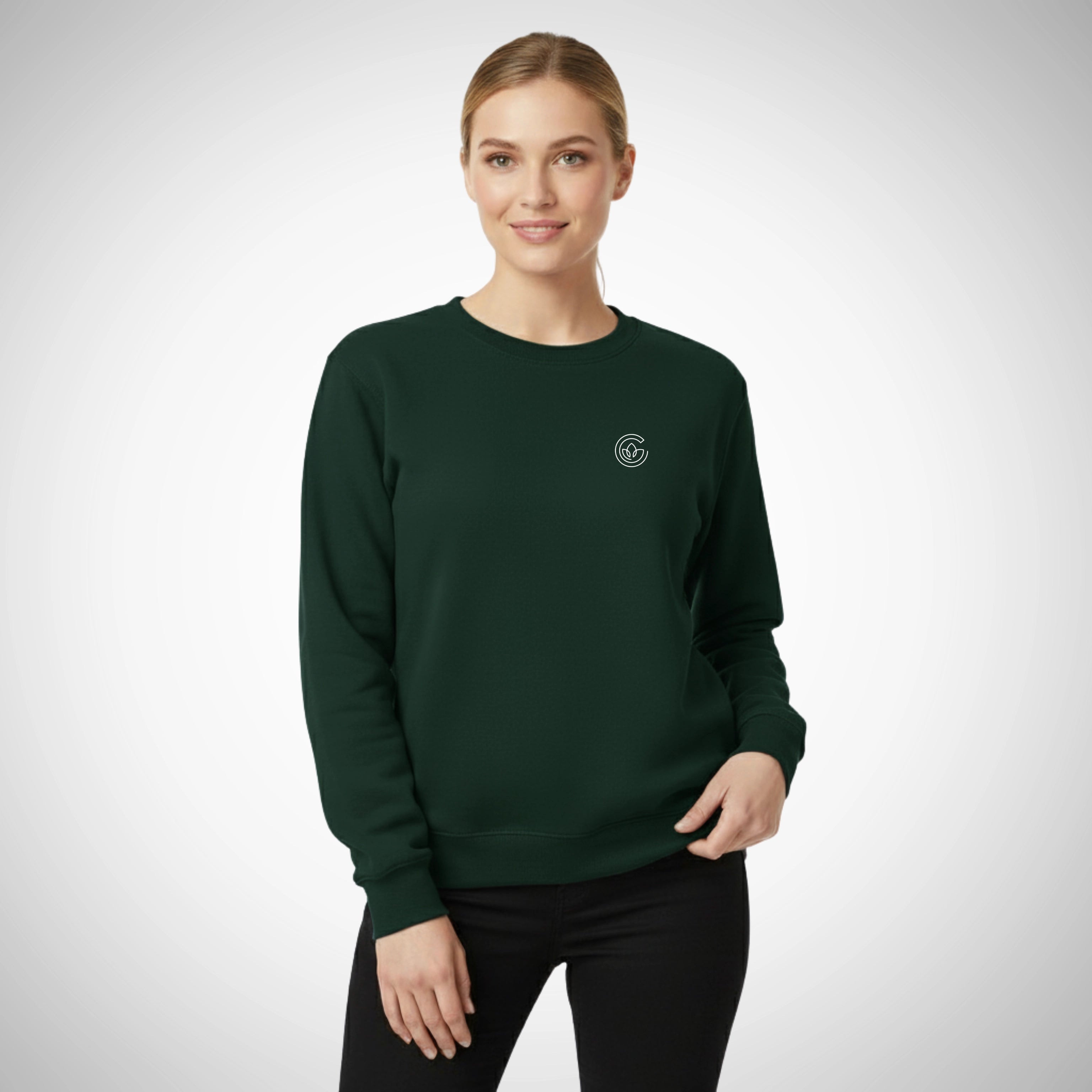 Woman wearing a dark green sweatshirt with a logo on a light gray background