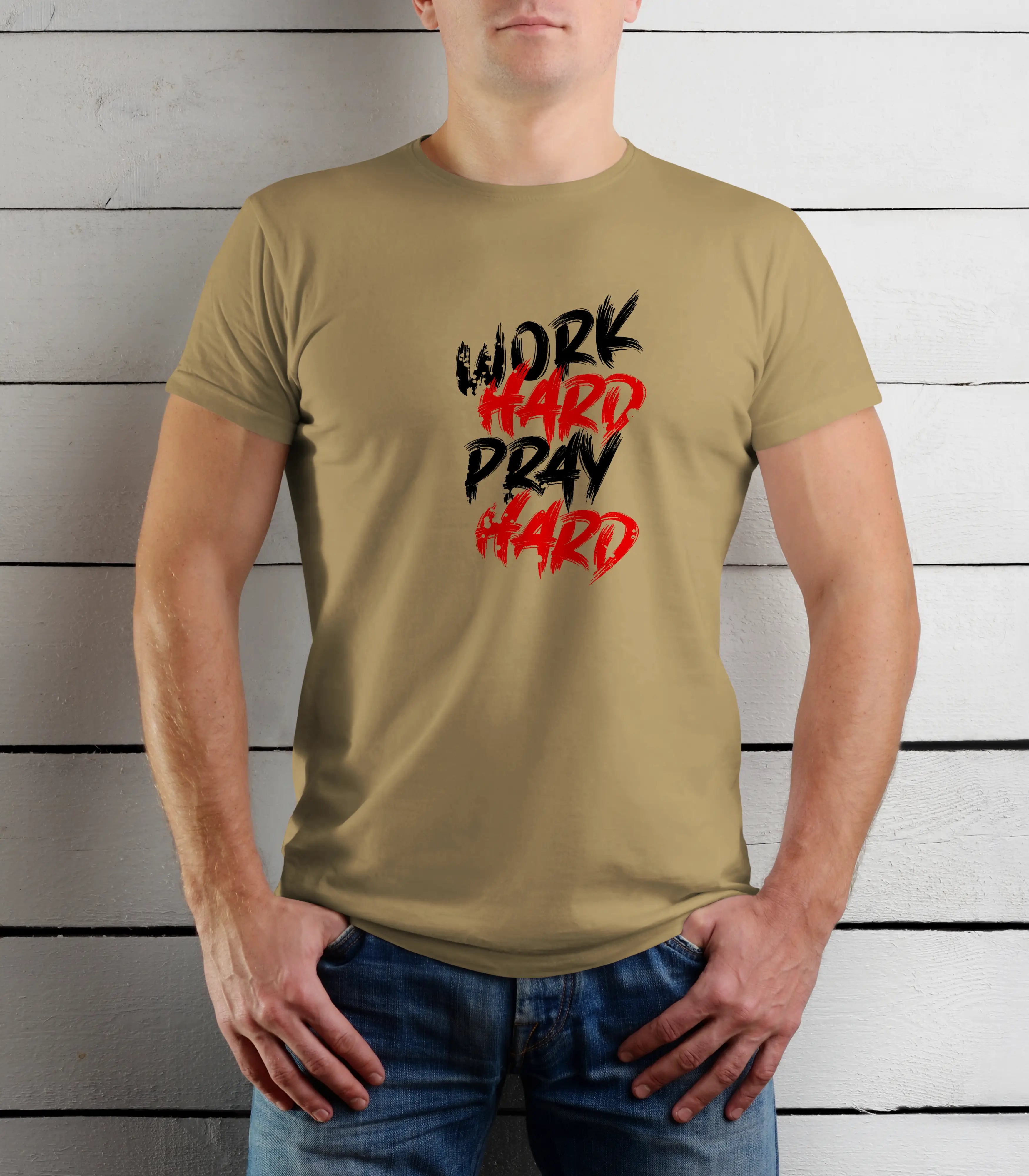 Person wearing a beige t-shirt with 'Work Hard Pray Hard' text in black and red against a wooden background