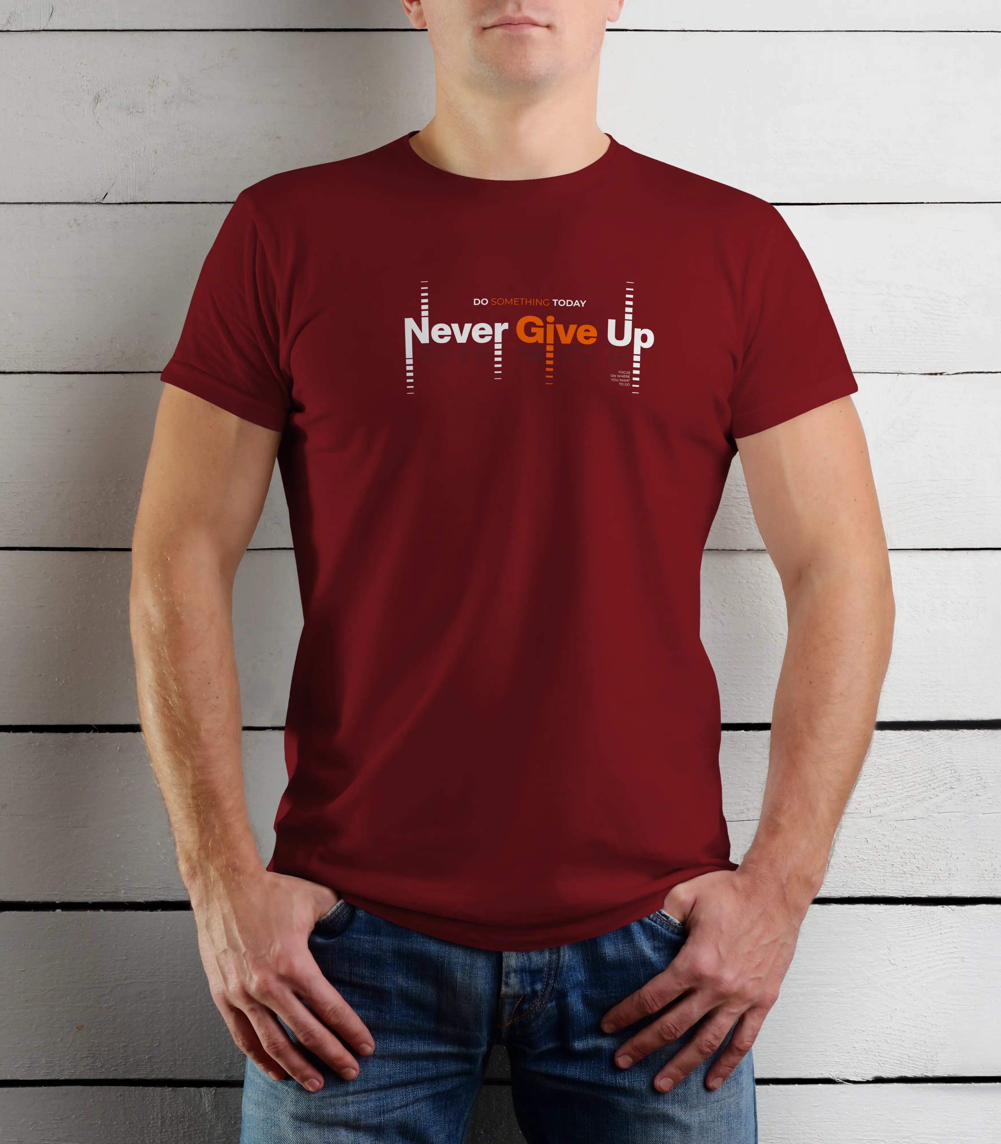 Person wearing a maroon t-shirt with 'Never Give Up' text against a wooden background