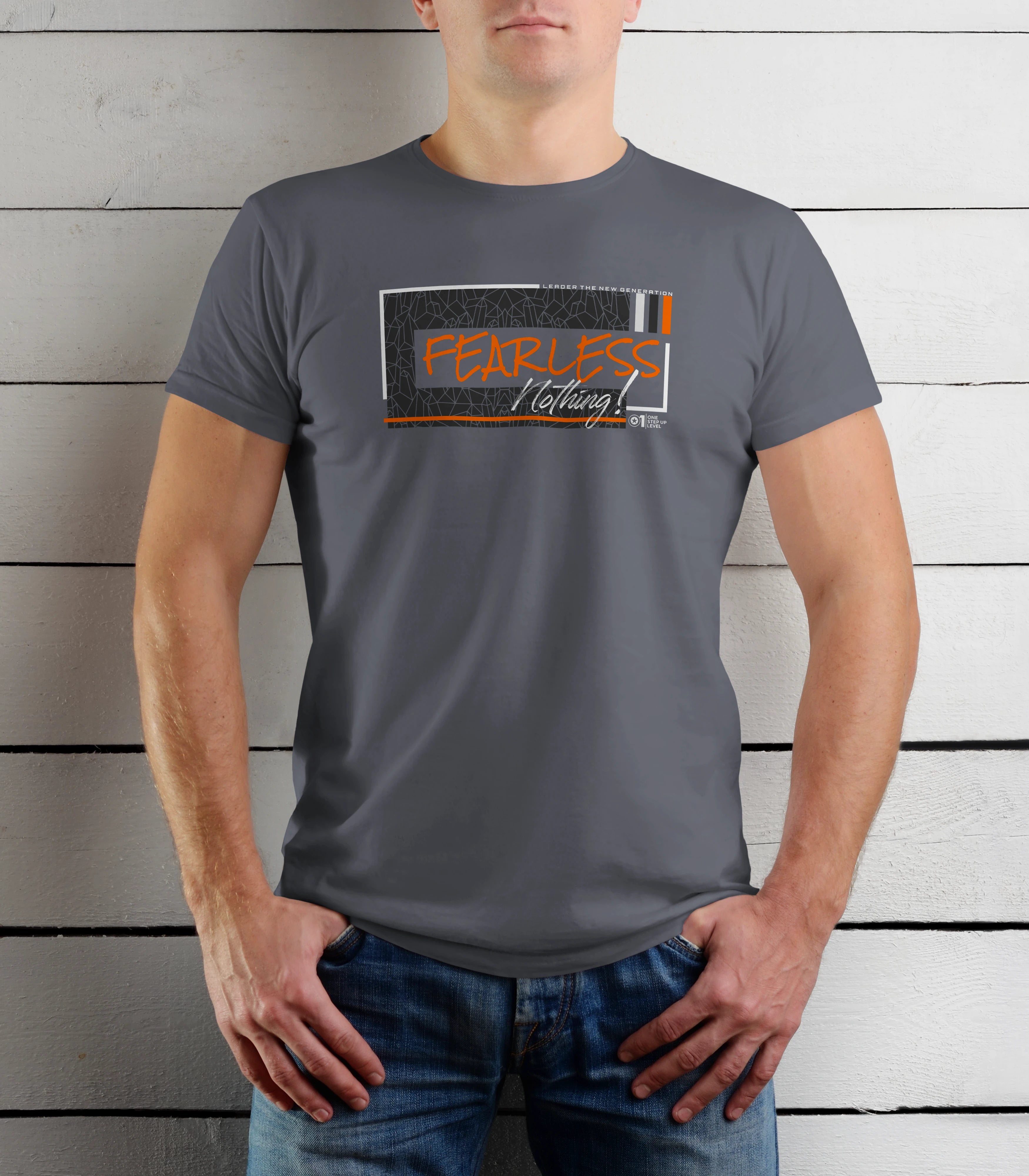 Person wearing a gray t-shirt with a graphic design on a wooden background