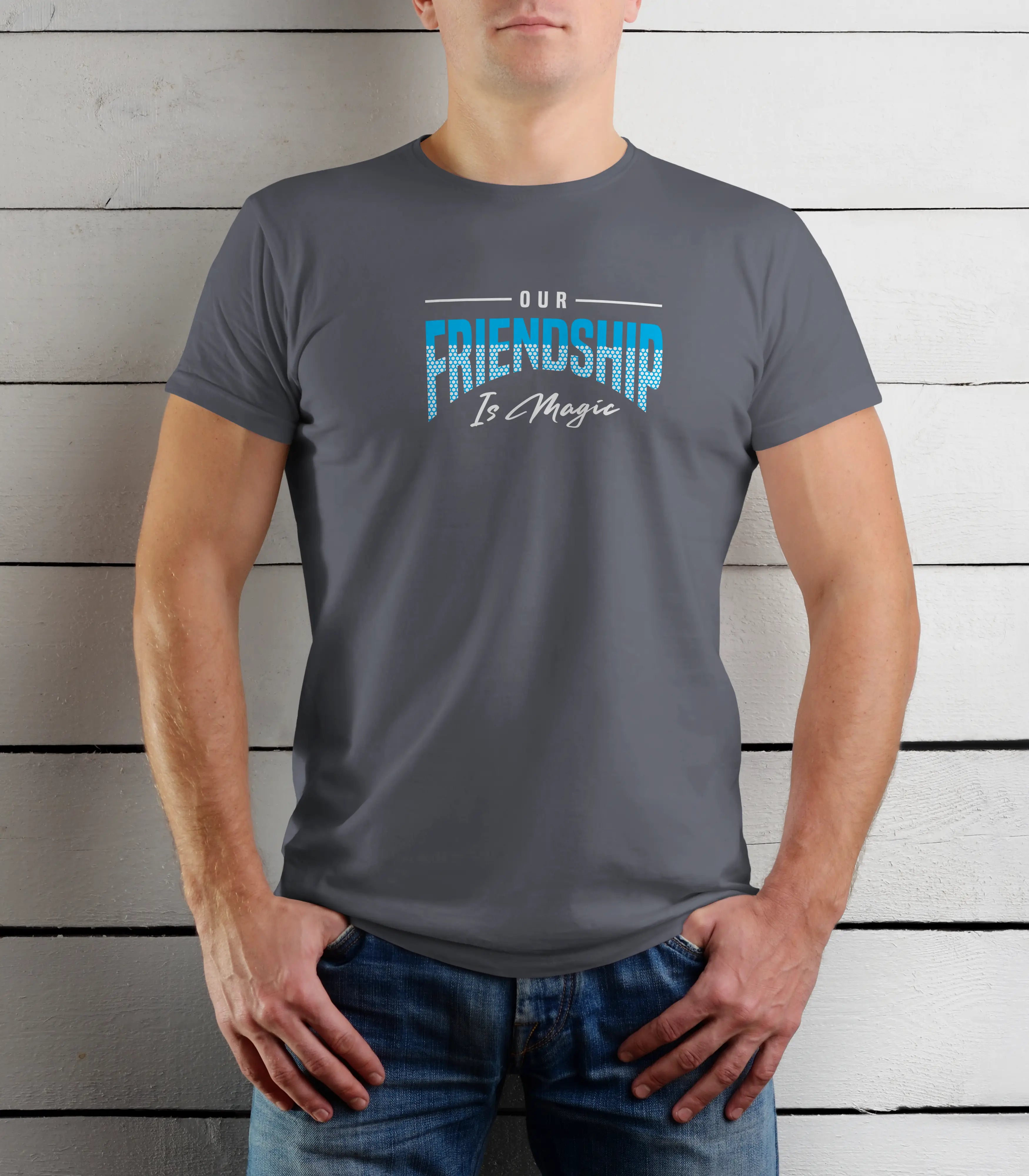 Person wearing a gray t-shirt with 'Our Friendship Is Magic' text against a wooden background