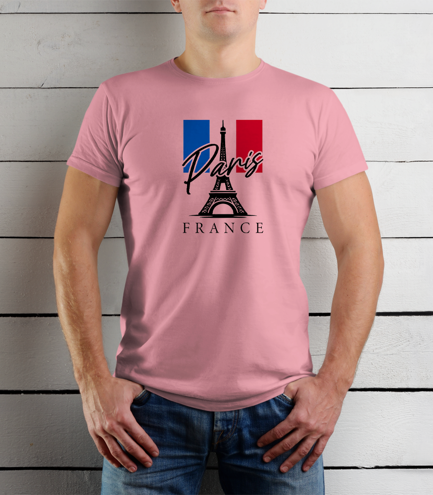 Person wearing a pink t-shirt with Paris and France design against a wooden background